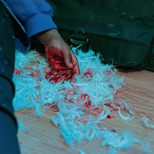 Bloody hand resting on a pile of white feathers, dark background.