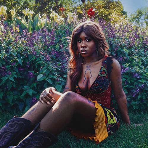 Kara Jackson album cover featuring a woman in a floral dress, seated in grass.