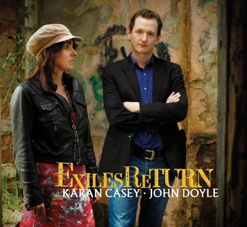 "CD cover featuring a man and woman standing outdoors, with 'Exiles Return' text."