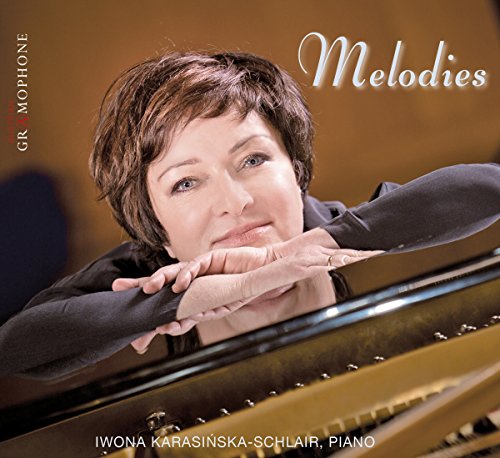 Iwona Karasińska-Schlair resting her chin on her hands over a grand piano.
