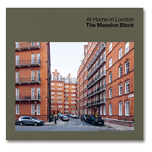 Red brick London mansion block buildings line a street with parked cars.