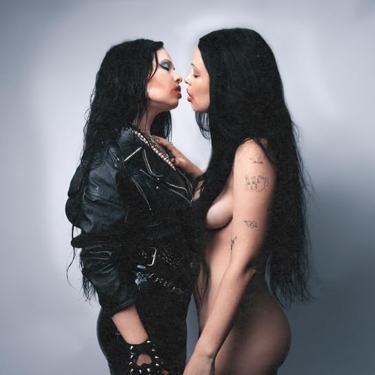 Two women with long dark hair facing each other, intimate pose.