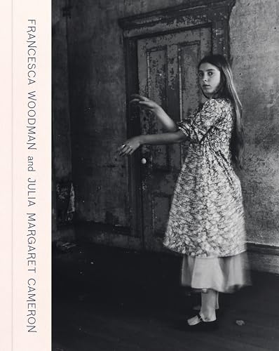 A black and white photograph of a young girl standing in a rustic room.