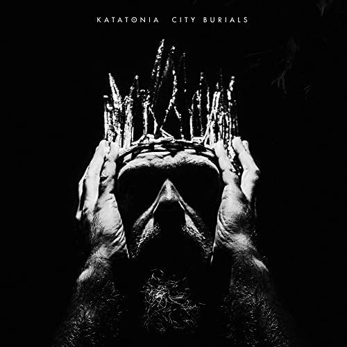 Dark album cover for Katatonia’s “City Burials” featuring hands and a face.