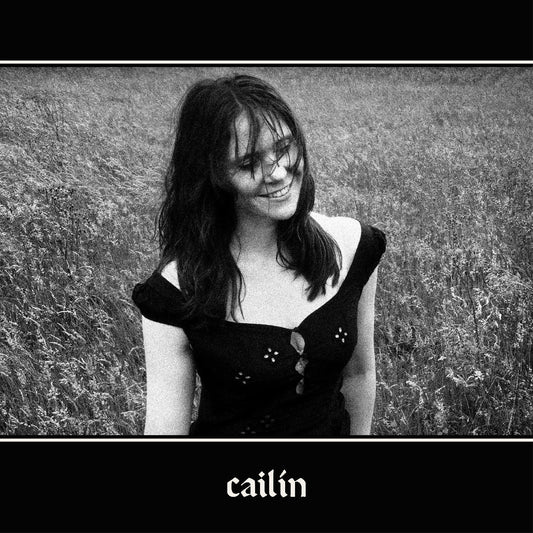 Black and white album cover featuring Kate Nash in a field, smiling.