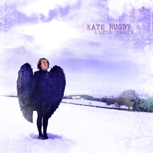 A woman with large black wings stands in a snowy field under a purple sky.
