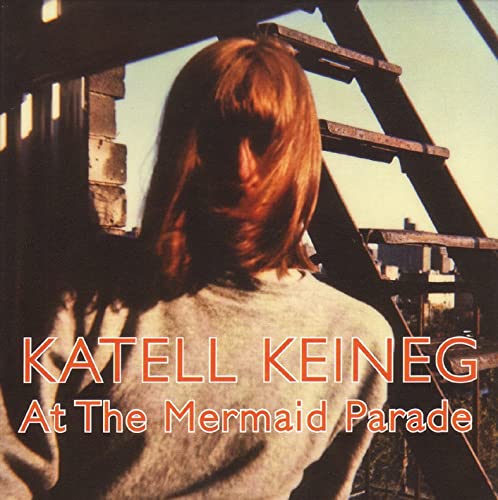 CD cover featuring a woman with red hair, viewed from behind.