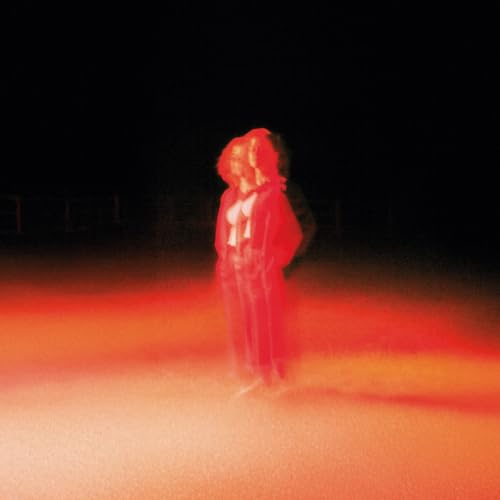 Red-toned album cover featuring a person standing in hazy light.