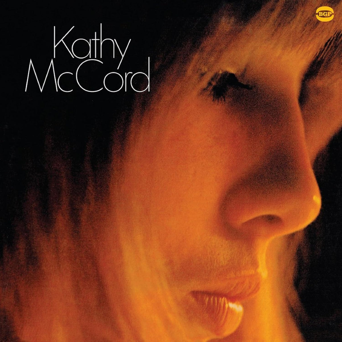 Kathy McCord album cover: close-up portrait in warm orange tones.