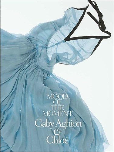 Light blue dress with black straps on white background, text overlay reads Mood of Moment.