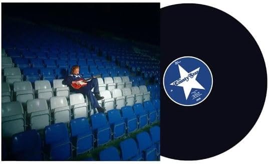 Vinyl record and album cover featuring a musician in a stadium.