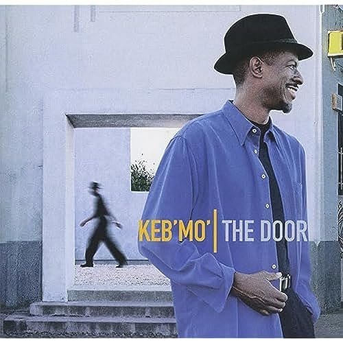 Keb Mo album cover, man in hat standing by a doorway.