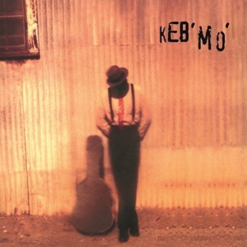 Vinyl record album cover featuring a man standing with a guitar case.