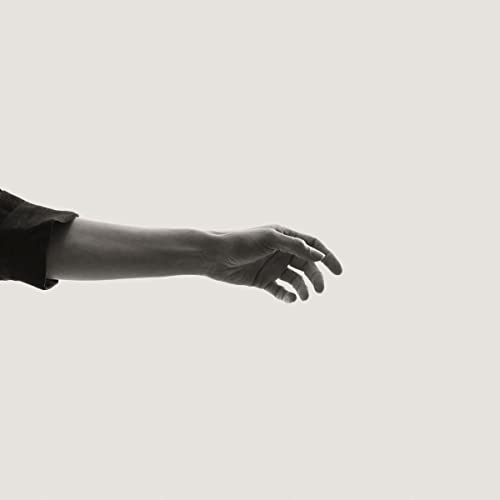 Black and white image of an outstretched human hand and arm.