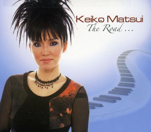 Album cover featuring Keiko Matsui with piano keys curving behind her on blue background.