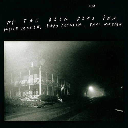 Black and white album cover depicting a foggy building and deer.