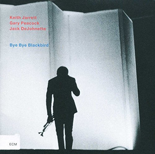 "Album cover featuring a man holding a trumpet, standing in a white-lit doorway."
