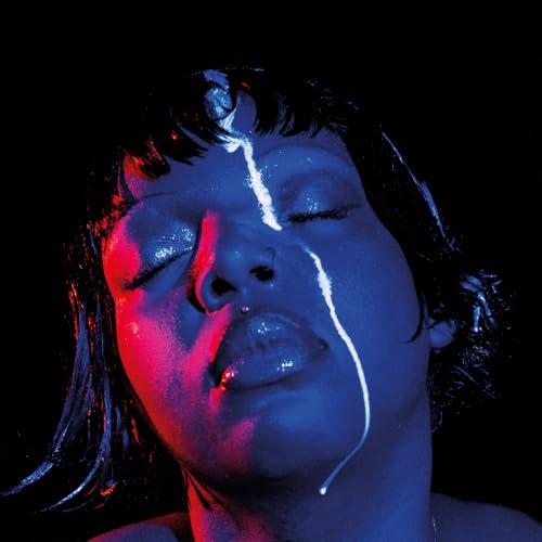 Close-up portrait of a person with blue and red lighting, wet hair.