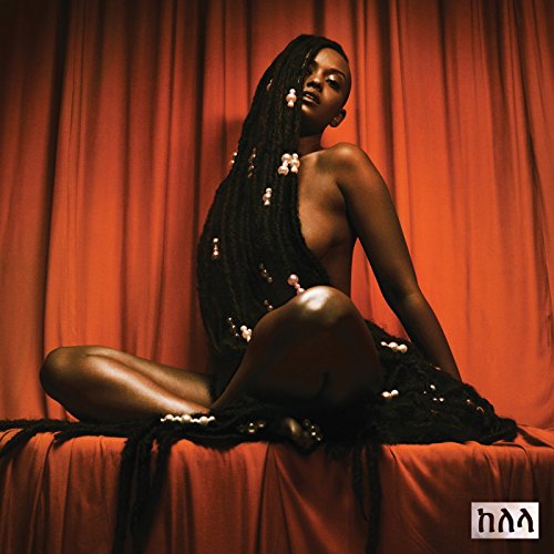 Kelela album cover: a dark-skinned woman with long braided hair sits partially draped.