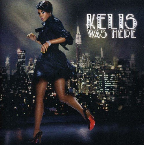 Kelis album cover, showing the artist in a black dress against a city skyline.