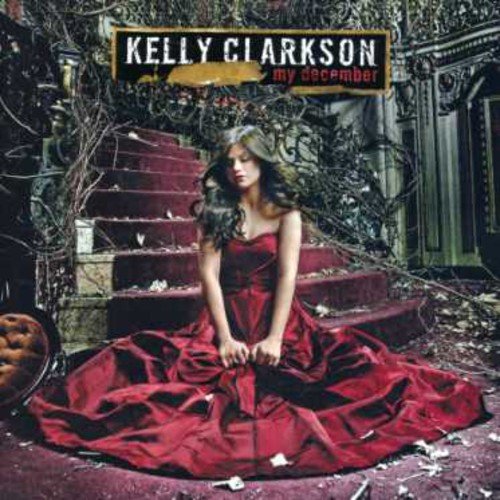Kelly Clarkson album cover, woman in red dress on steps.