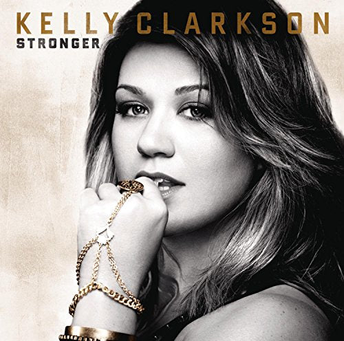 Kelly Clarkson's "Stronger" album cover, a portrait with gold jewelry.