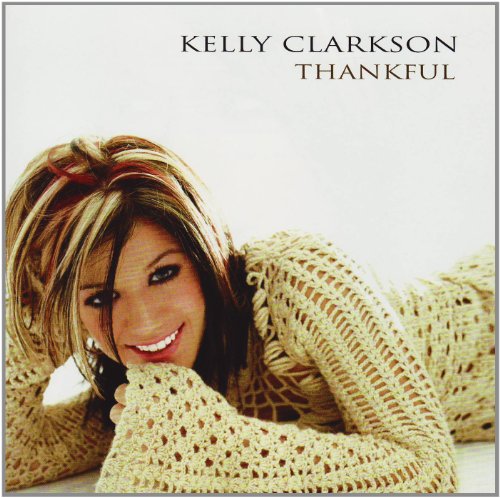 Kelly Clarkson album cover, "Thankful," featuring a smiling woman in a sweater.