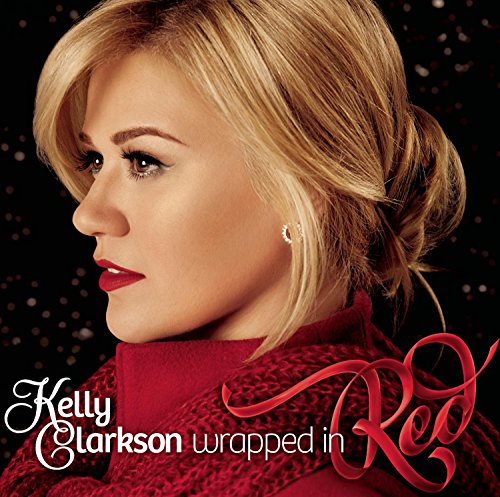 Kelly Clarkson album cover, portrait of a woman in red, with text.