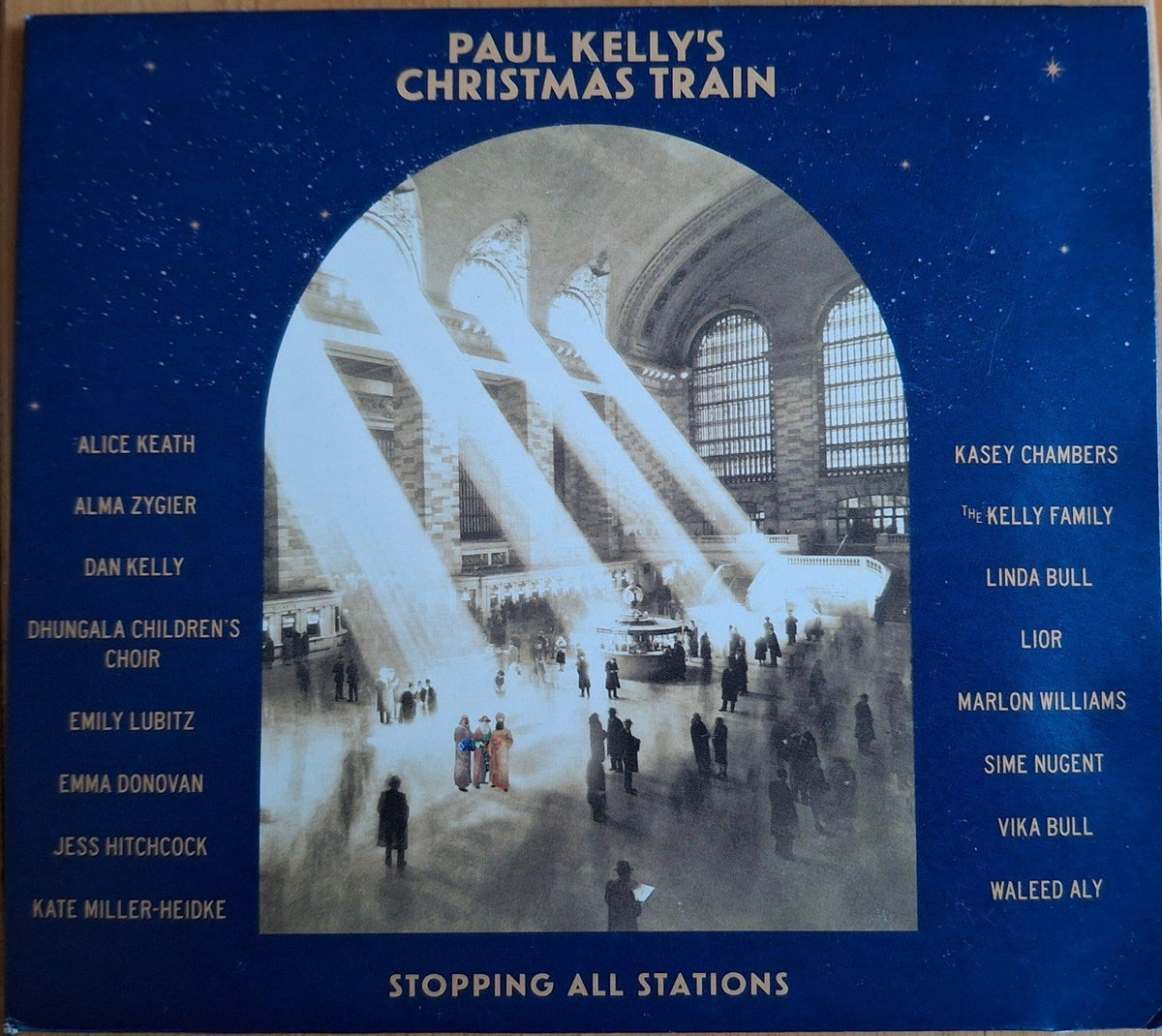 CD cover for "Paul Kelly's Christmas Train" featuring a train station scene.