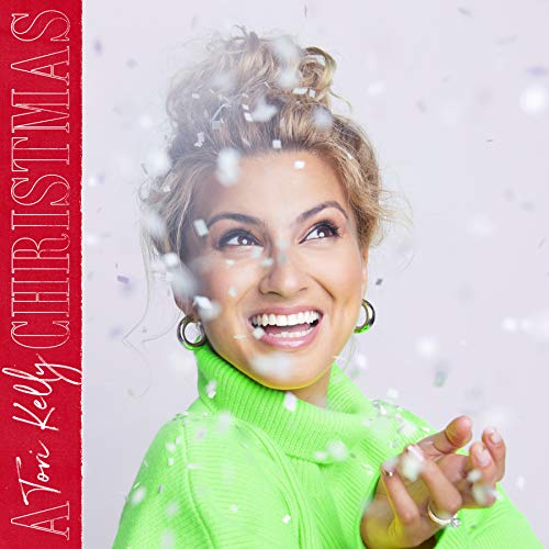 Tori Kelly smiling, surrounded by snowflakes, on a Christmas album cover.