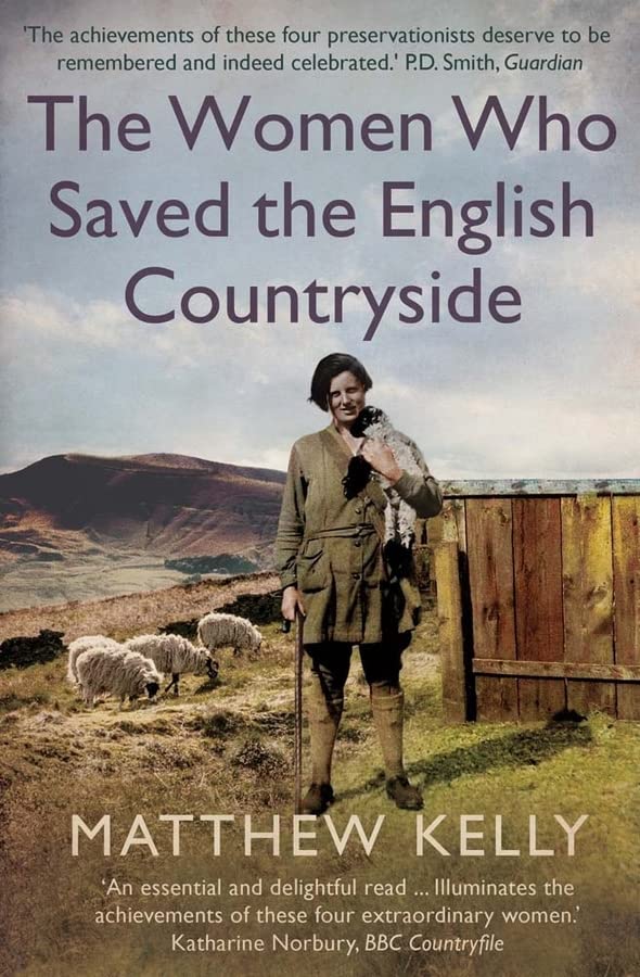 Woman in tweed jacket holding lamb with sheep and hills in background.