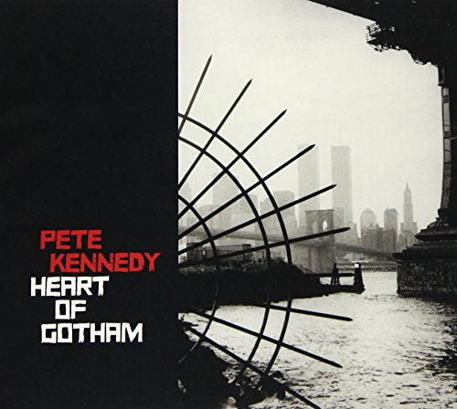 "Album cover with black-and-white cityscape, metal grid, and artist name 'Pete Kennedy' in red."