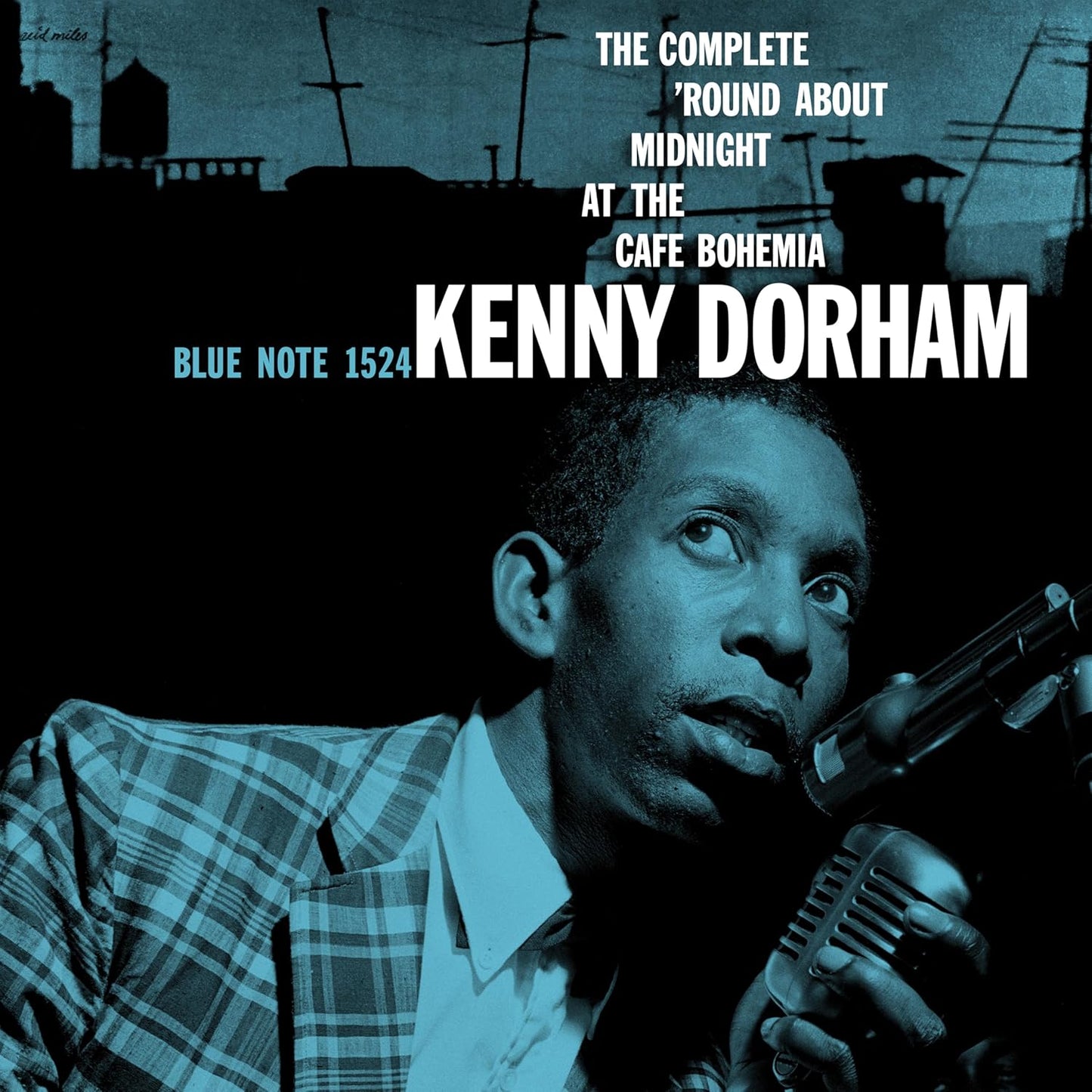 Kenny Dorham in a plaid jacket holding a microphone on a blue-tinted album cover.