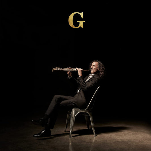 Kenny G playing a saxophone, seated on a chair against a dark background.
