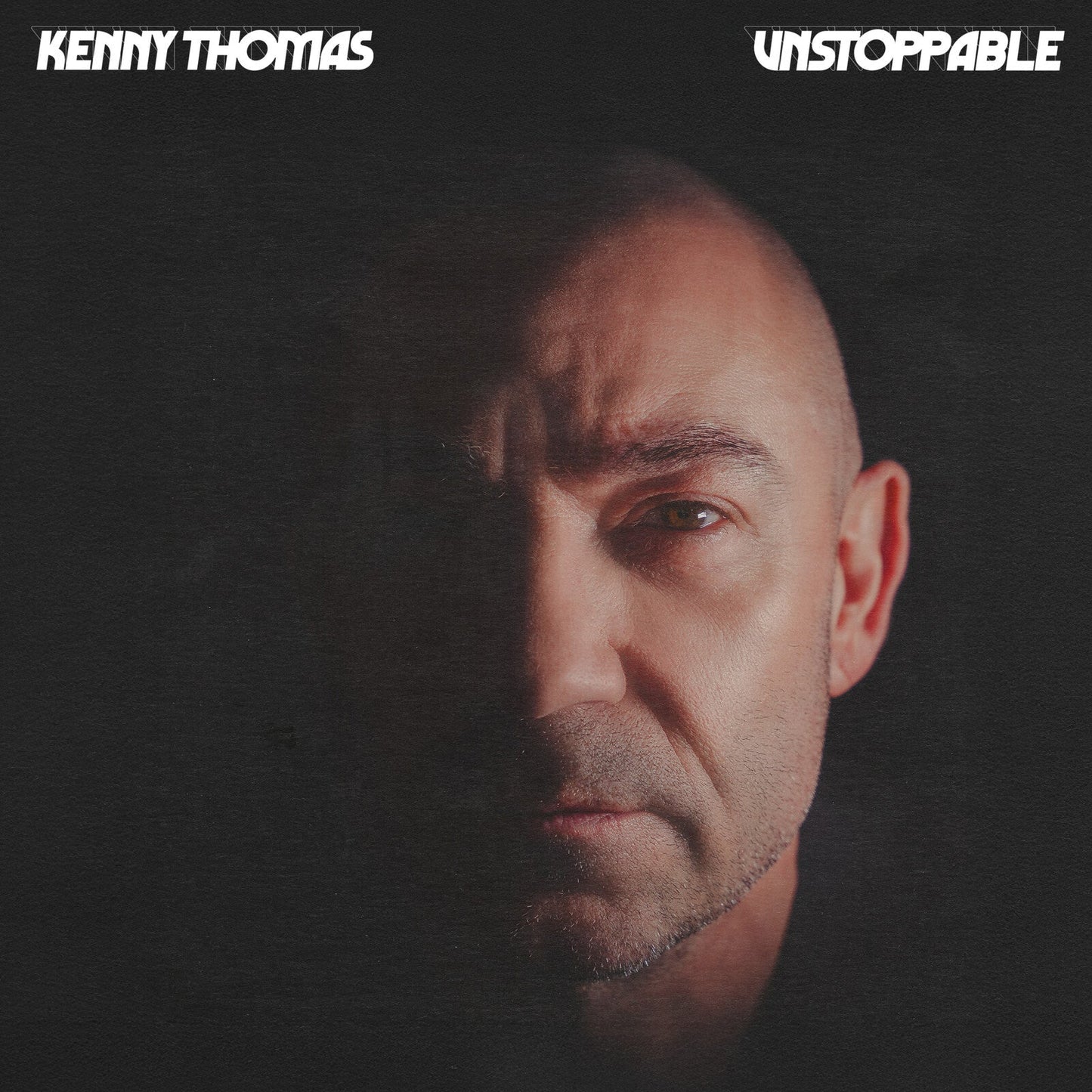 CD cover for Kenny Thomas’ “Unstoppable,” featuring a close-up portrait.