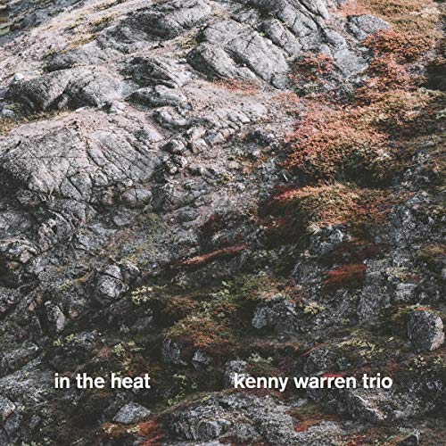 Album cover for Kenny Warren Trio’s “In The Heat” with rocky terrain.
