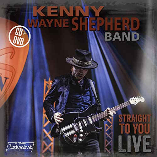 Kenny Wayne Shepherd playing electric guitar on stage with a CD plus DVD label.