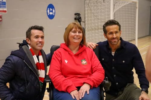 Kerry Evans with Ryan Reynolds and Rob McElhenney, smiling indoors.