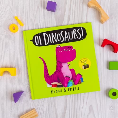 Bright green children’s book, “Oi Dinosaurs!”, with a cartoon pink dinosaur.