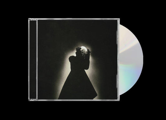 CD case with a silhouetted figure holding flowers against a dark background.