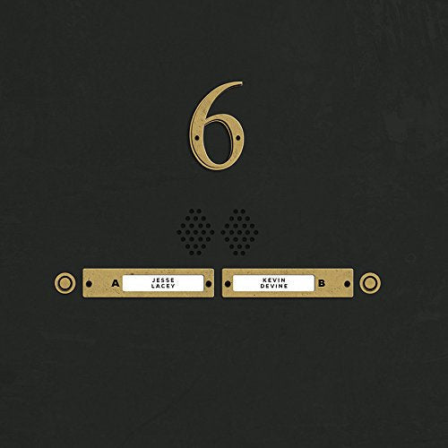 A black intercom panel with a gold number six and nameplates for Jesse Lacey.