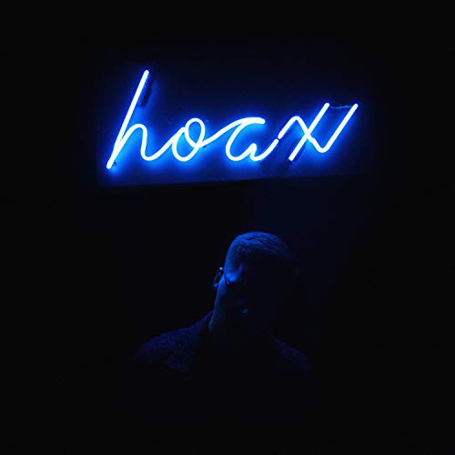 "Man's silhouette under a neon sign reading 'hoax' in blue cursive letters."