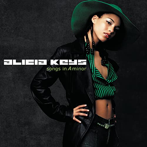 Alicia Keys wearing a green hat and leather jacket on her album cover.