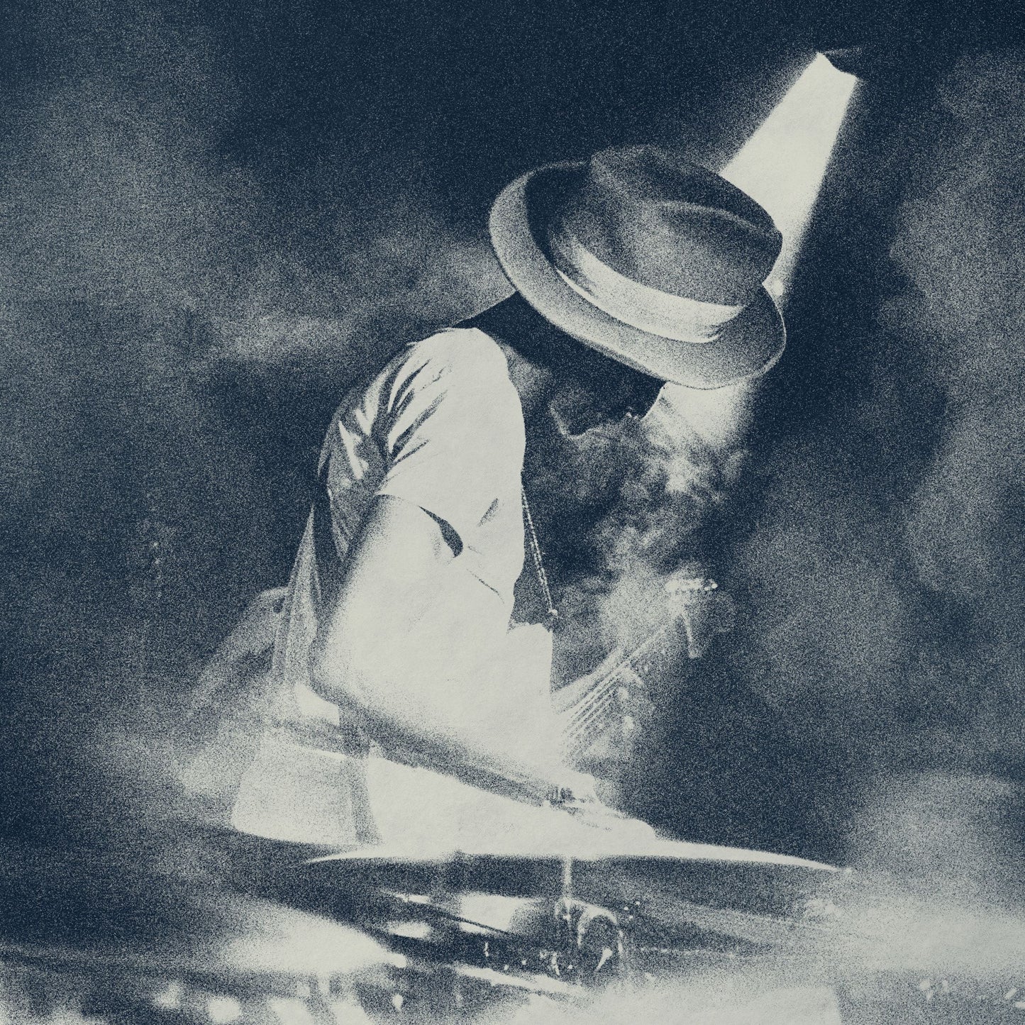 Black and white image of Keziah Jones playing guitar onstage.