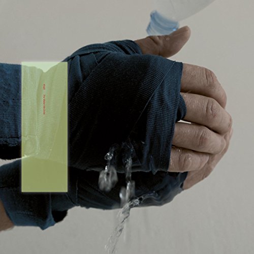 A hand wearing a blue glove with water pouring from it.