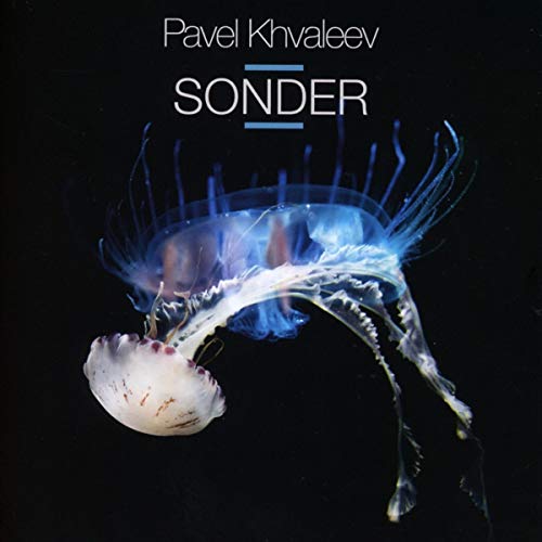 Album cover featuring a glowing jellyfish against a black background with artist and title text.
