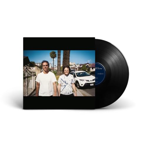 Vinyl record with cover art showing two men standing on a sunny residential street.