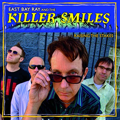 Four men in sunglasses stand in front of a blue wall on a CD cover.