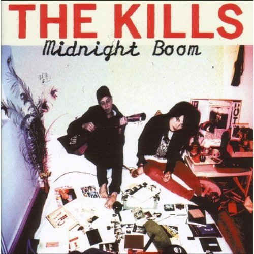The Kills album cover: two figures on a bed with scattered items.