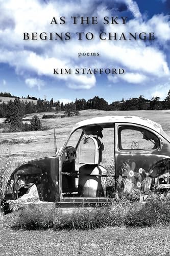 Poetry book cover with a rusted car in a field under clouds.